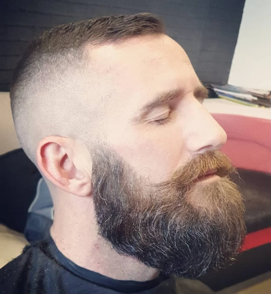 Full beard with shaped moustache, side profile